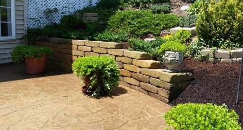 Garden with stone retaining wall and patio