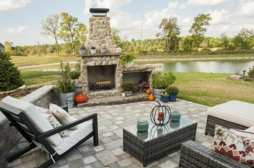 Outdoor stone patio with furniture and fireplace