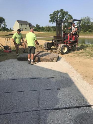 Men cutting stone for patio