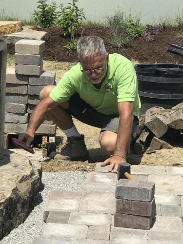 Man installing stone patio
