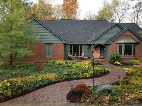 Front of house with plants and brick pathway